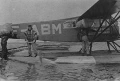 Airplane with three men loading fur at Coppermine